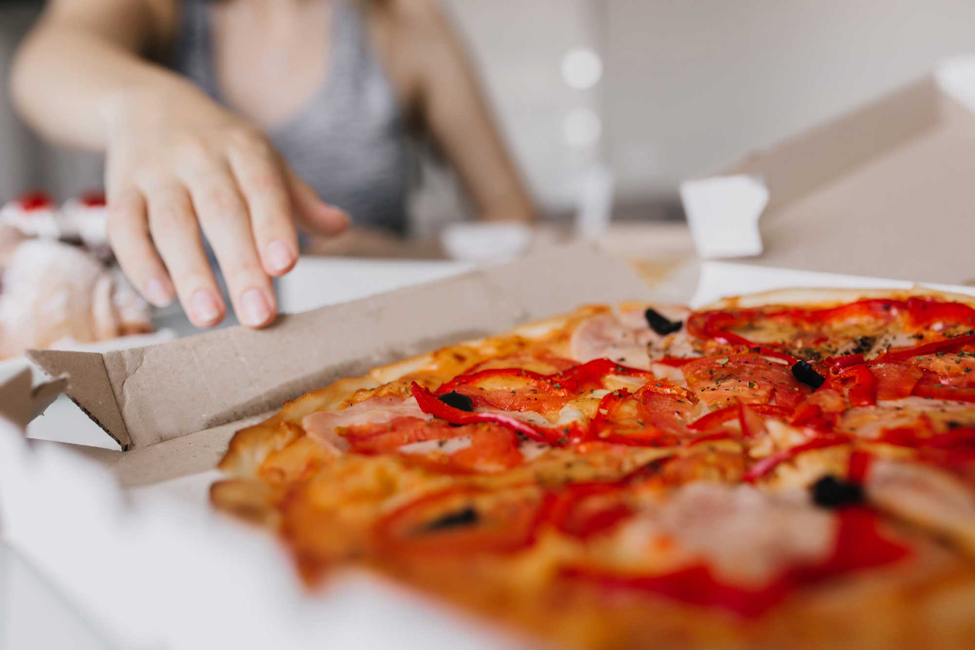 indoor-portrait-of-white-woman-with-pizza-on-foreg-2024-09-24-05-01-01-utc