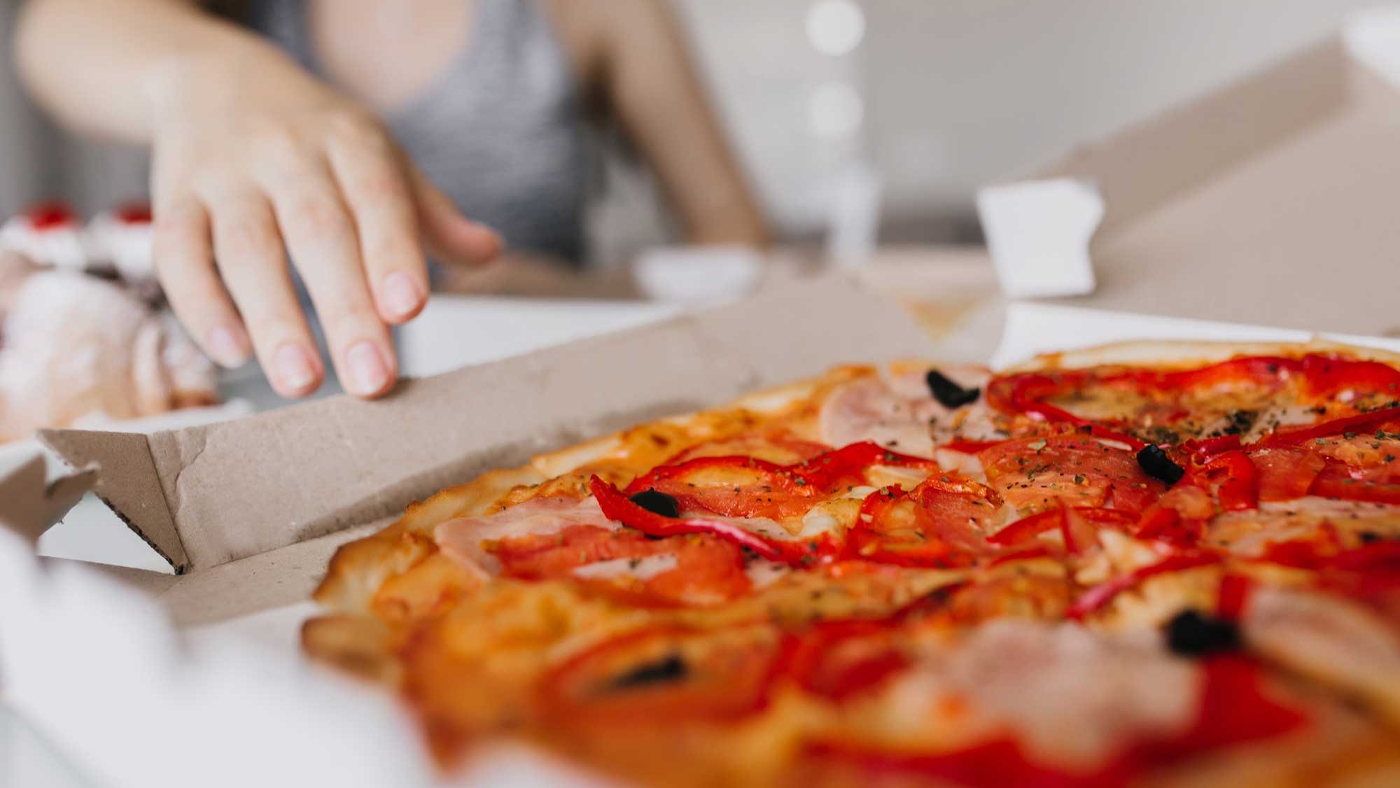 indoor-portrait-of-white-woman-with-pizza-on-foreg-2024-09-24-05-01-01-utc